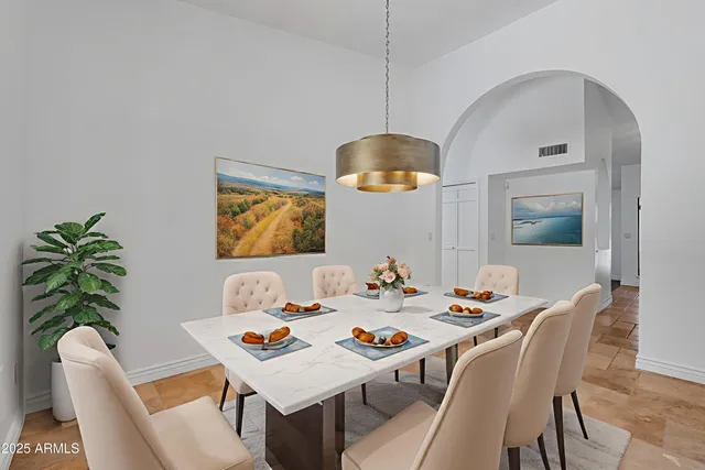 a view of an empty room with a chandelier fan