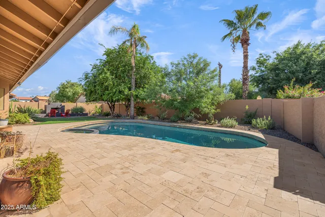 a view of a house with swimming pool and porch