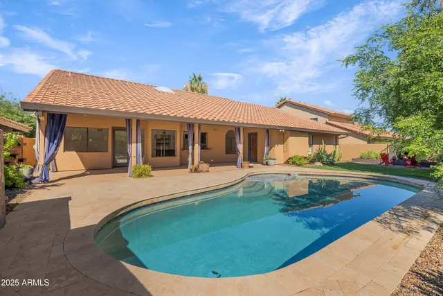 a view of a house with backyard sitting area and garden