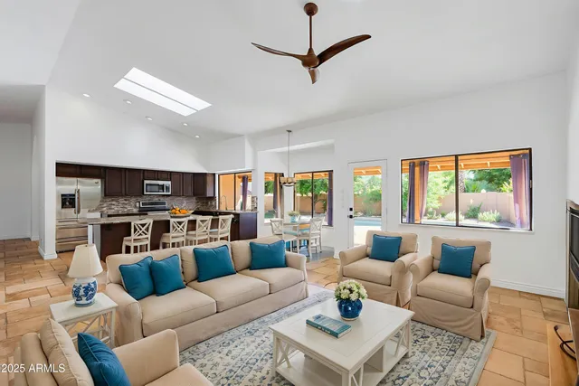 a large kitchen with stainless steel appliances a large counter top a stove and a refrigerator