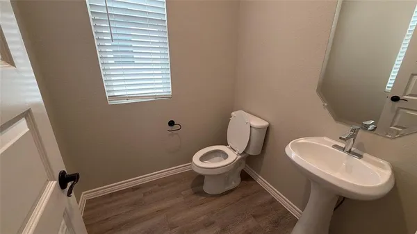 a bathroom with a toilet sink and a mirror