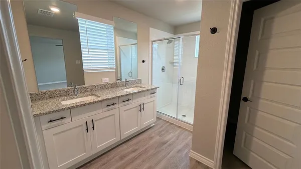 a bathroom with granite countertop a sink and a mirror
