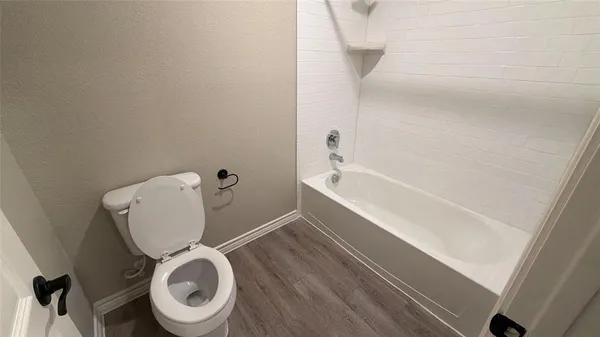 a bathroom with a toilet and a bathtub