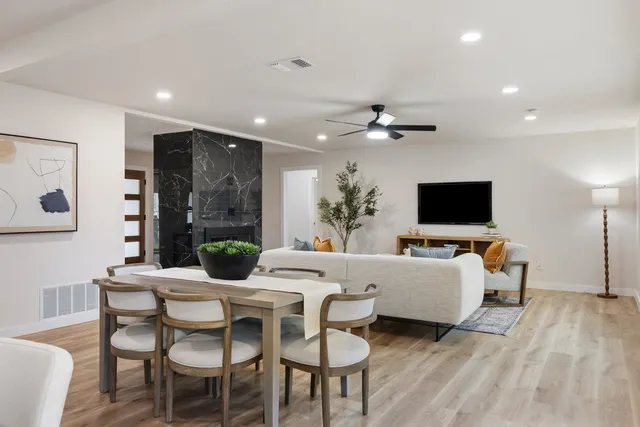 a view of a dining room with furniture and wooden floor