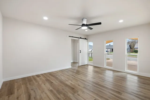 wooden floor in an empty room with a window