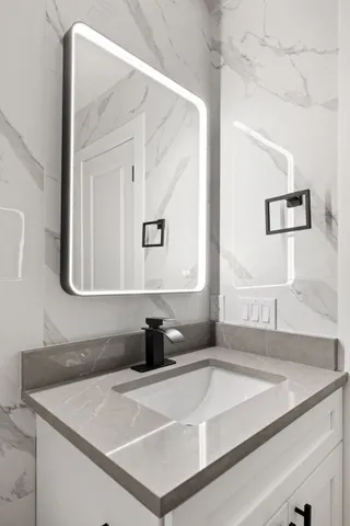 a bathroom with a sink and a mirror