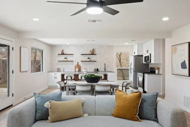 a living room with furniture and a chandelier