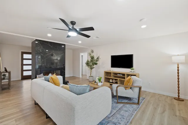 a living room with furniture and a flat screen tv