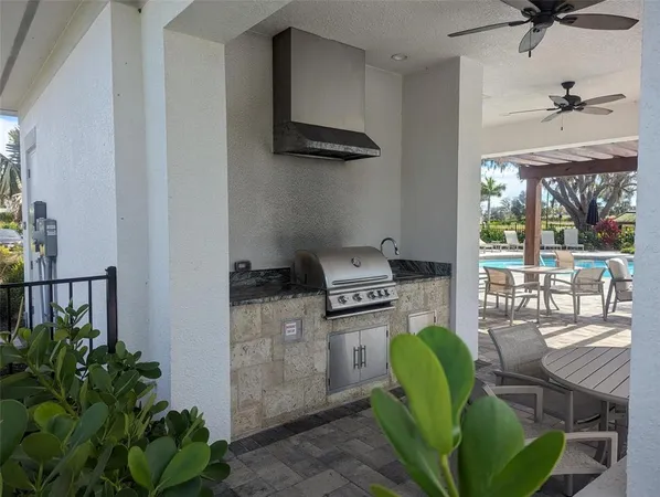 a view of swimming pool with outdoor seating and plants