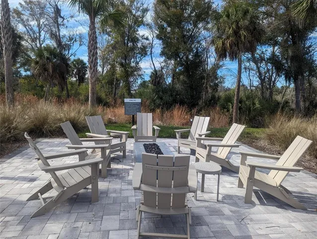 a living room with furniture a flat screen tv and a large window