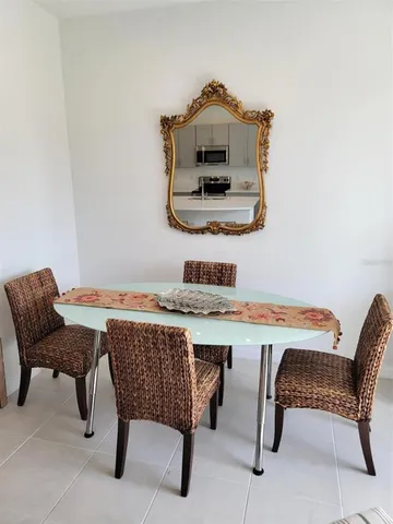 a living room with a table and chairs