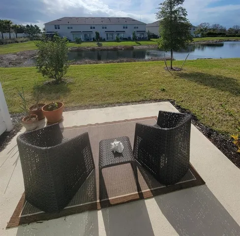 a living room with furniture a window and gym equipment
