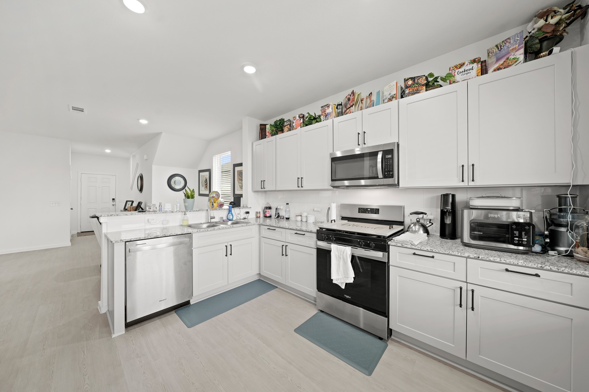 26235 Arrowleaf Drive Magnolia, TX 77355 - Photo 11 of 32 a kitchen with white cabinets and white appliances