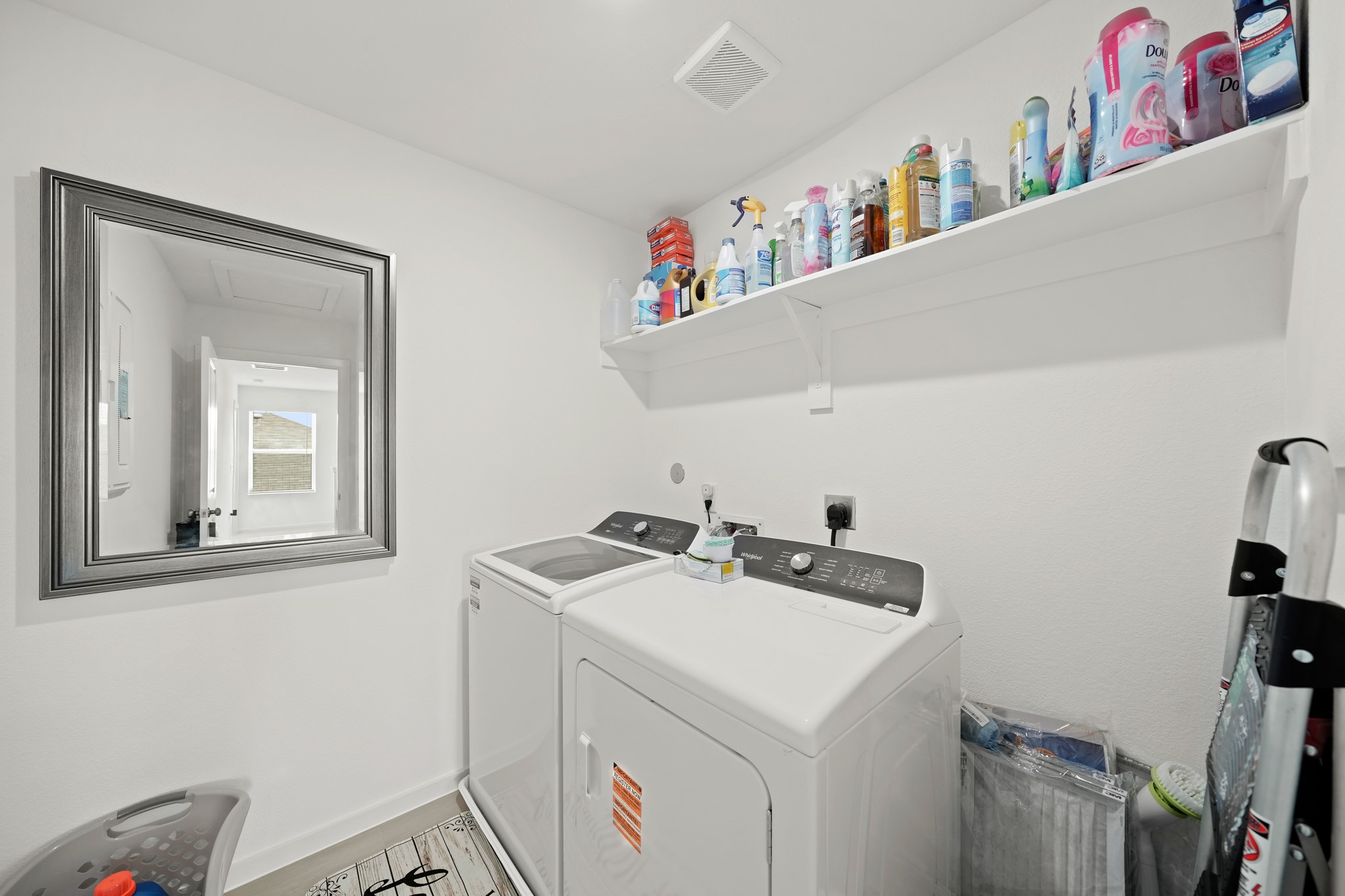 26235 Arrowleaf Drive Magnolia, TX 77355 - Photo 14 of 32 a utility room with dryer washer and a fridge