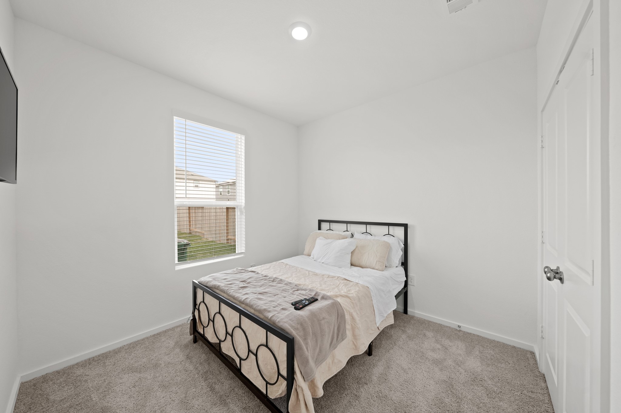 26235 Arrowleaf Drive Magnolia, TX 77355 - Photo 16 of 32 a bed sitting in a bedroom next to a window
