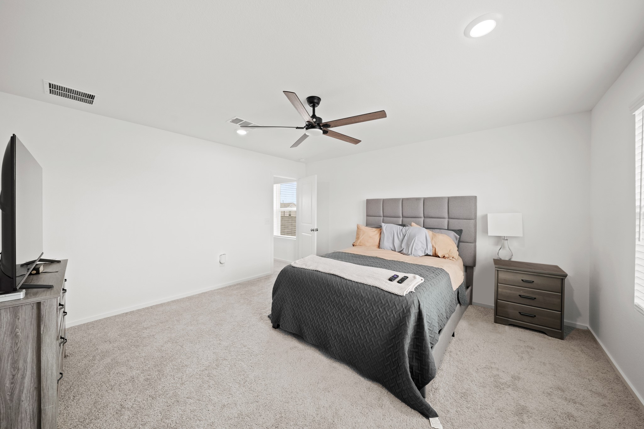 26235 Arrowleaf Drive Magnolia, TX 77355 - Photo 23 of 32 a bedroom with a bed and a ceiling fan
