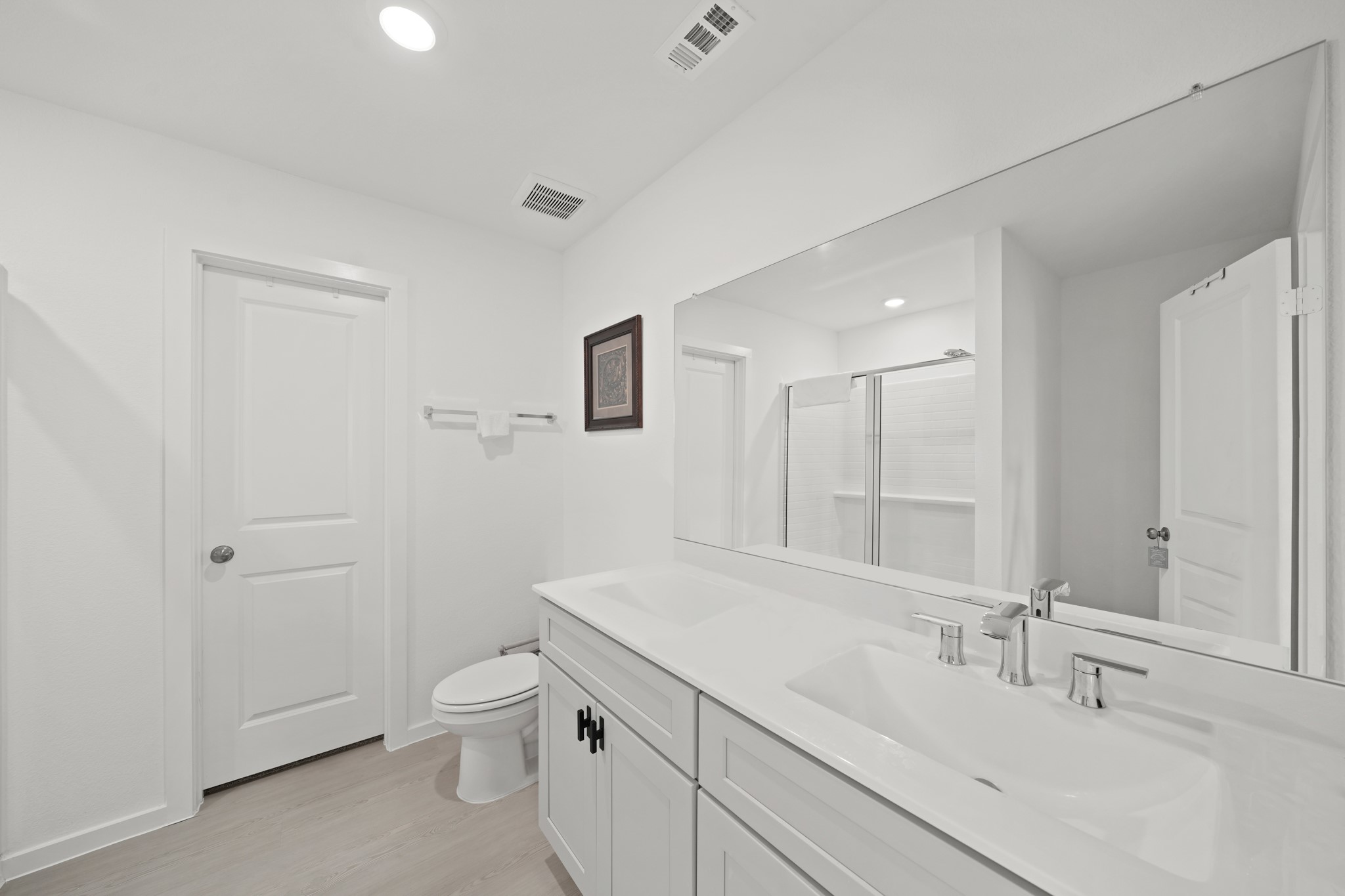 26235 Arrowleaf Drive Magnolia, TX 77355 - Photo 25 of 32 a bathroom with a sink a toilet and a large mirror