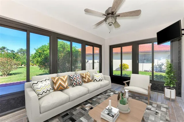 a view of an entryway with wooden floor and a livingroom