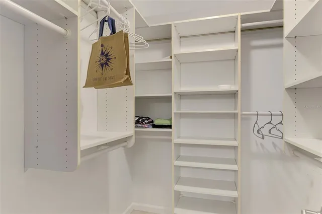 an empty room with closet and windows