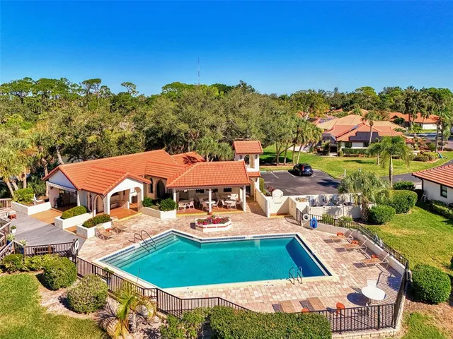 a view of a roof deck with table and chairs a barbeque with wooden floor and fence