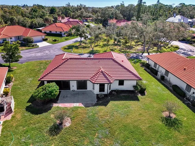 a living room with furniture wooden floor and a large window