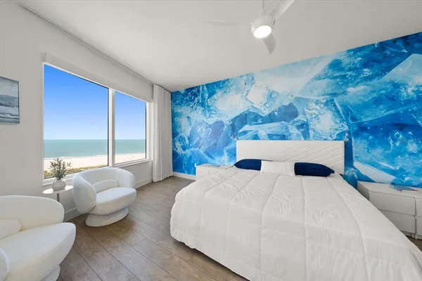 a bedroom with a bed and glass window