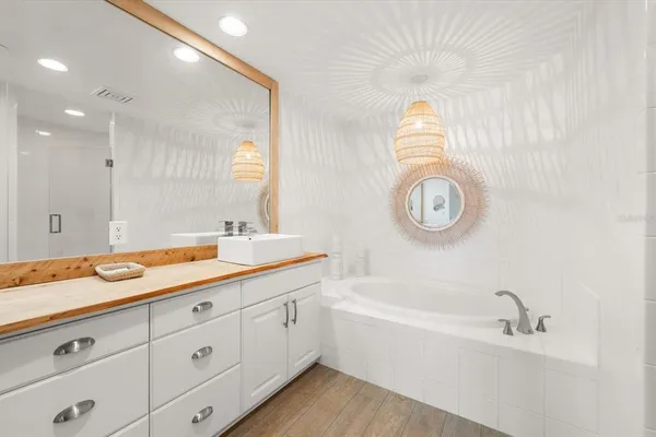 a bathroom with a double vanity sink and a bathtub