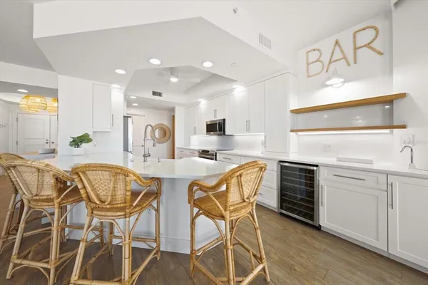 a view of a dining room with furniture and a kitchen