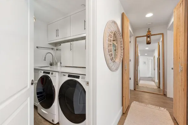 a view of a hallway with washer and dryer