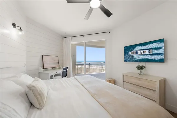 a bedroom with a bed a couch and a window