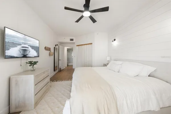 a spacious bedroom with a bed and a chandelier