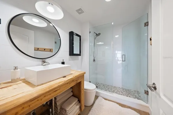 a bathroom with a sink a toilet and a mirror