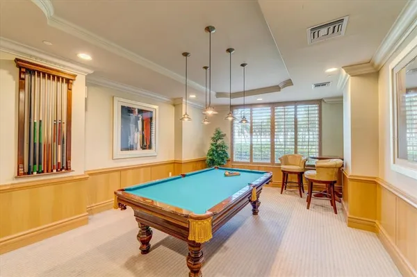 a room with pool table and windows