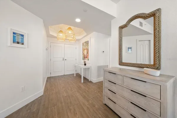 a view of bathroom with a sink mirror and window