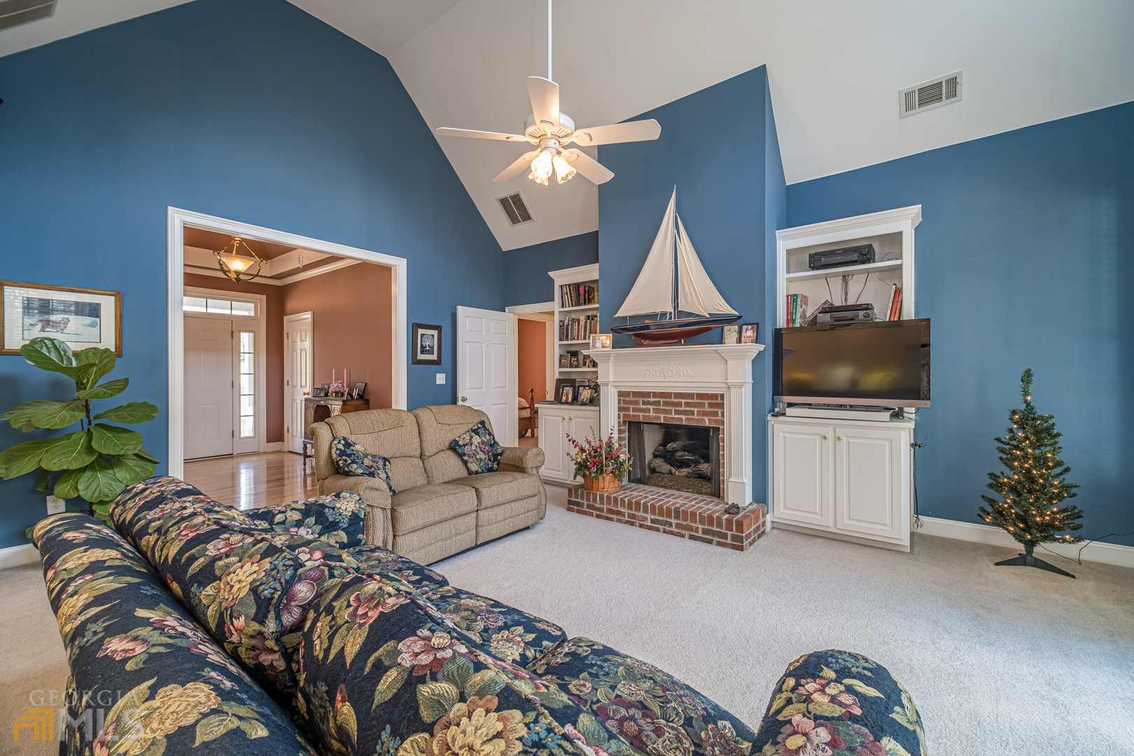 928 Grayson New Hope Road Lawrenceville, GA 30045 - Photo 24 of 36 a living room with furniture a fireplace and a chandelier