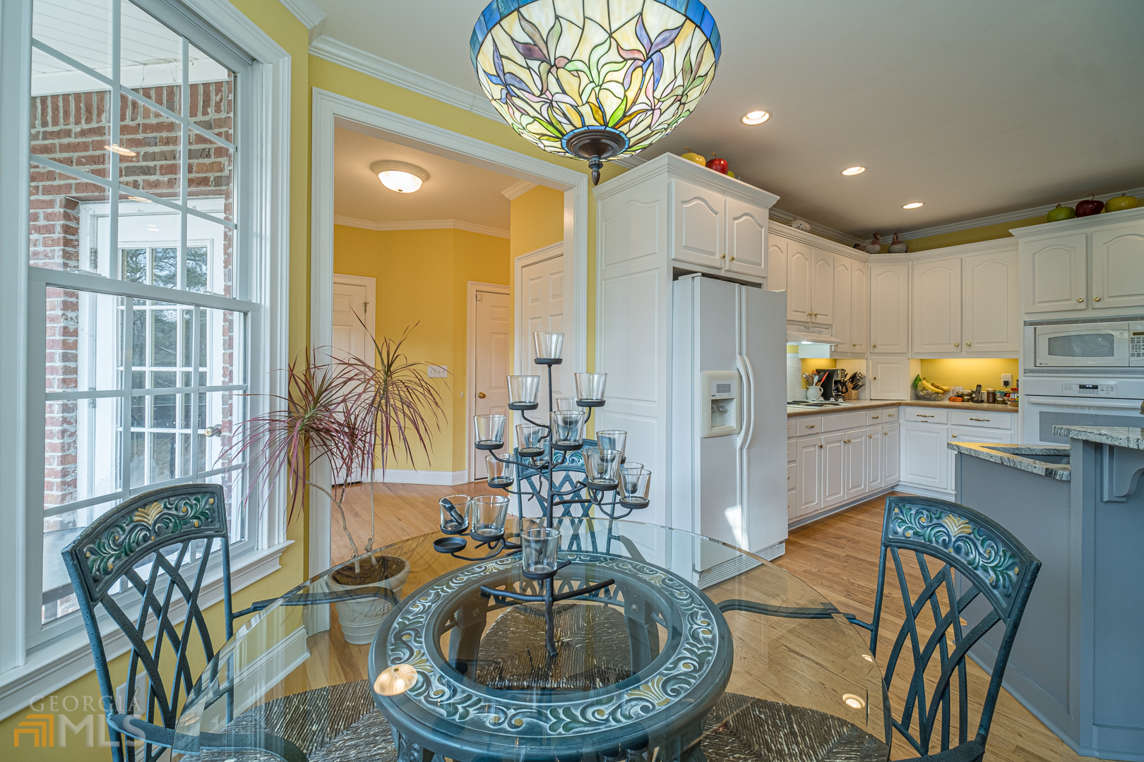 928 Grayson New Hope Road Lawrenceville, GA 30045 - Photo 26 of 36 a kitchen with sink refrigerator dining table and chairs