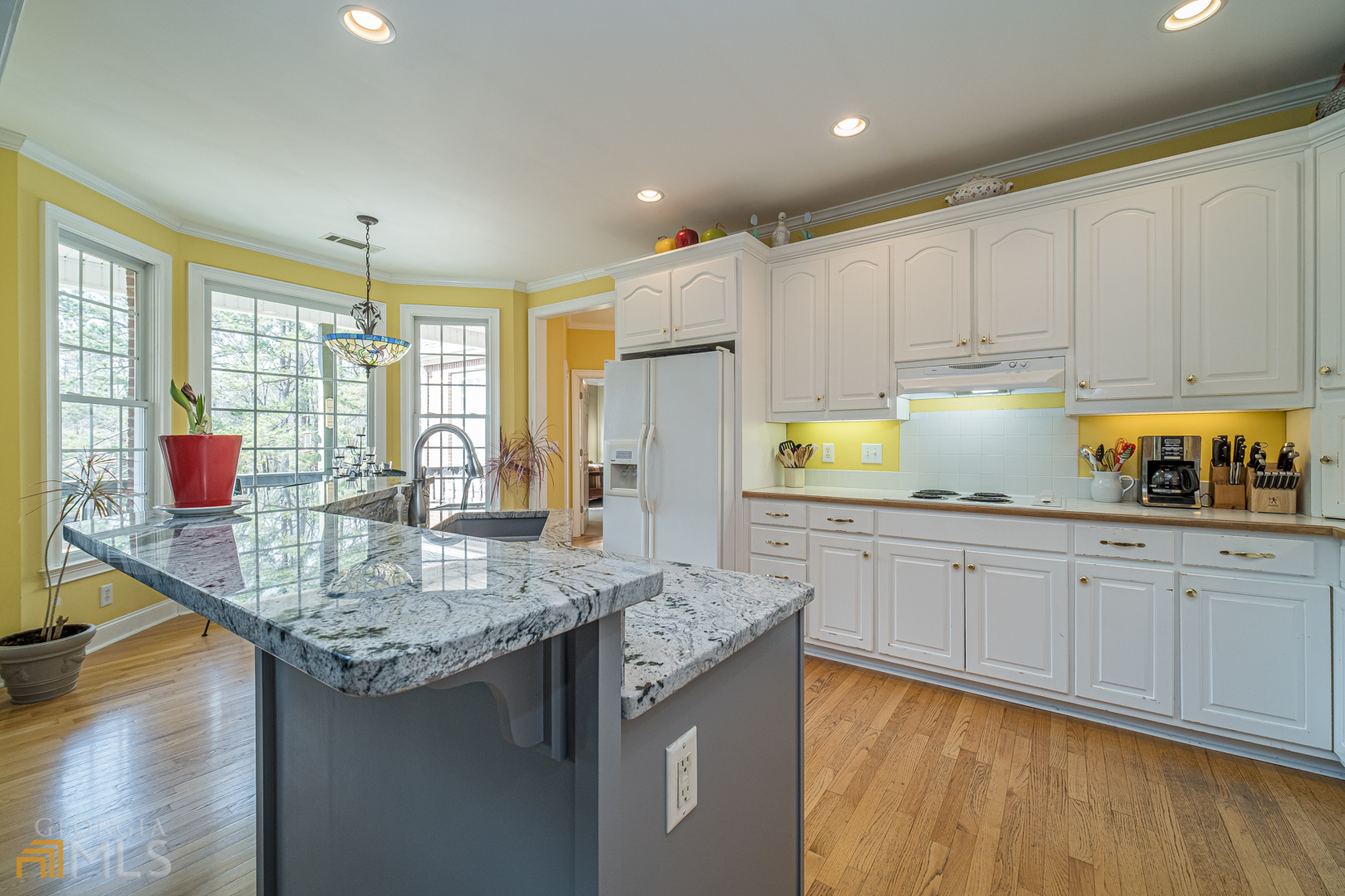 928 Grayson New Hope Road Lawrenceville, GA 30045 - Photo 28 of 36 a kitchen with stainless steel appliances granite countertop a sink stove and cabinets