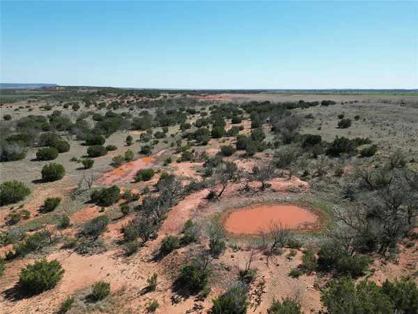 an aerial view of a houses with a yard