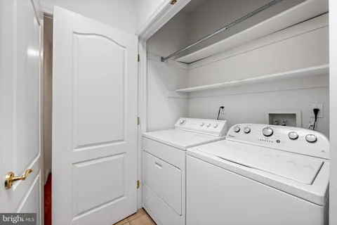 a view of storage and utility room with washer and dryer