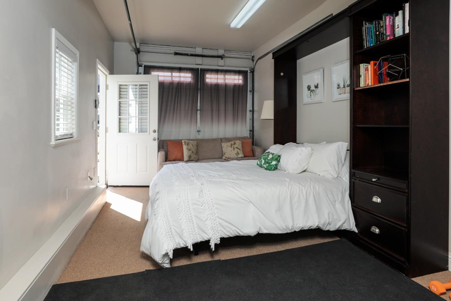 818 Crossway Road Burlingame, CA 94010 - Photo 28 of 50 a bedroom with a bed and a book shelf