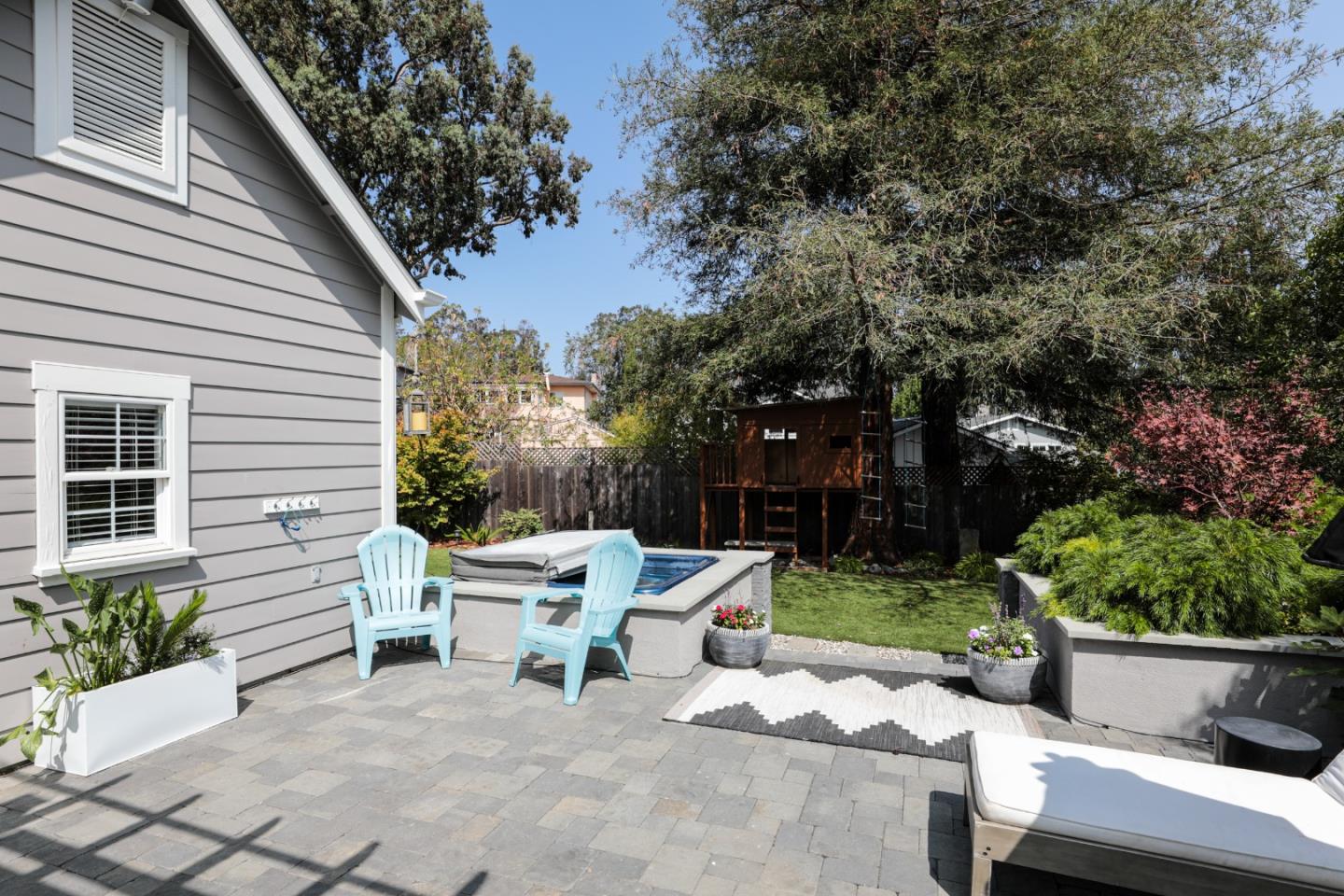 818 Crossway Road Burlingame, CA 94010 - Photo 32 of 50 a view of a chairs and table in the back yard of the house