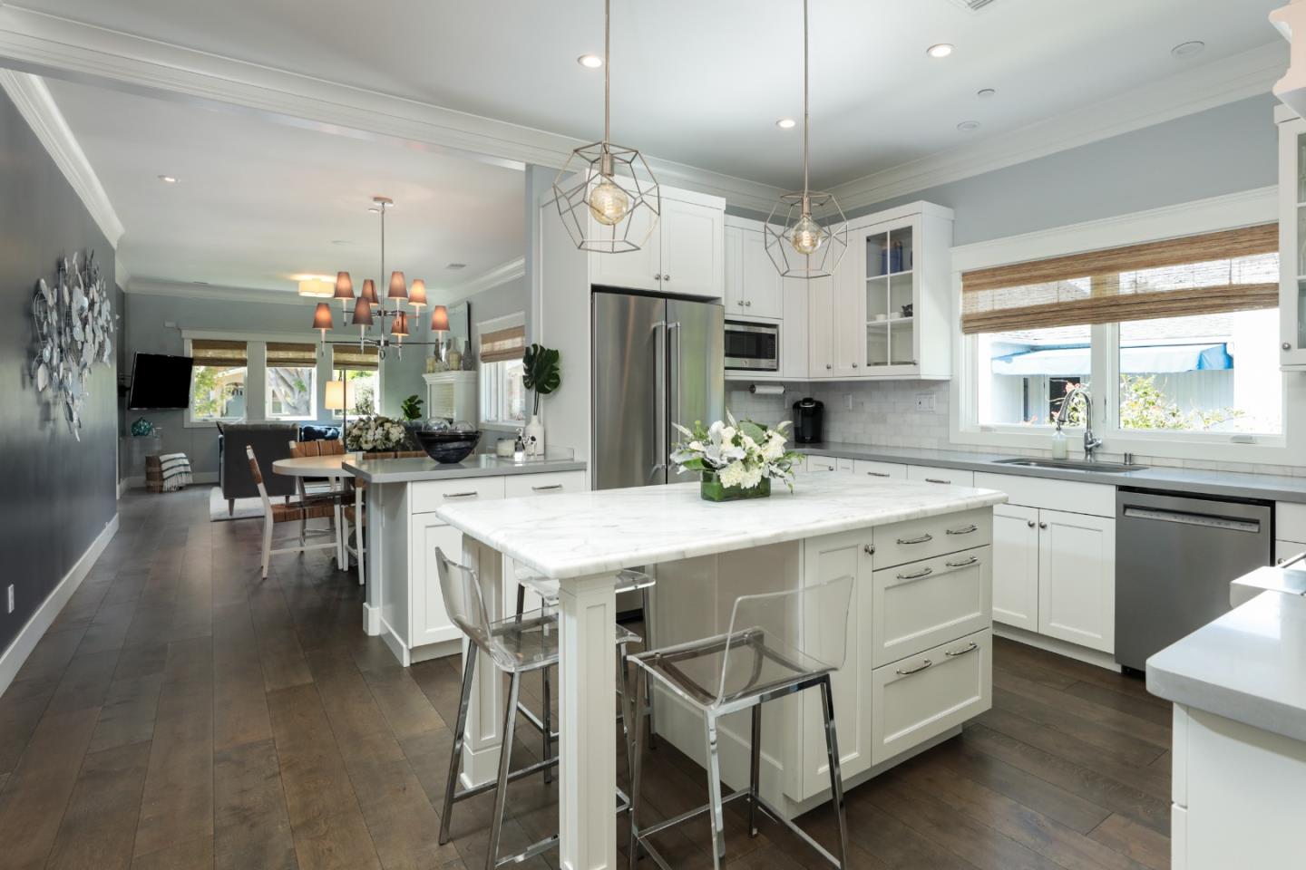 818 Crossway Road Burlingame, CA 94010 - Photo 8 of 50 a kitchen with stainless steel appliances kitchen island granite countertop a table chairs and a refrigerator