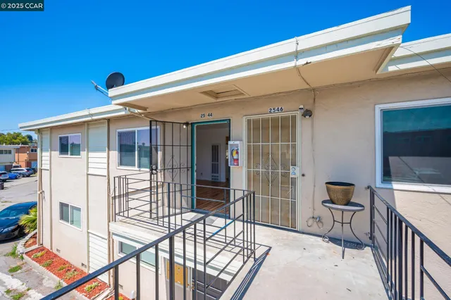 a balcony with table and chairs