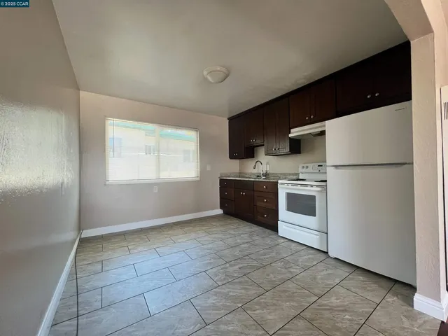 a kitchen with a stove a sink and a refrigerator