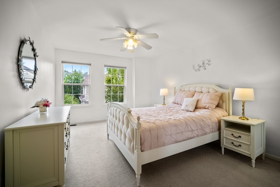 4643 Jenna Road Glenview, IL 60025 - Photo 8 of 17 a bedroom with a bed and a chandelier