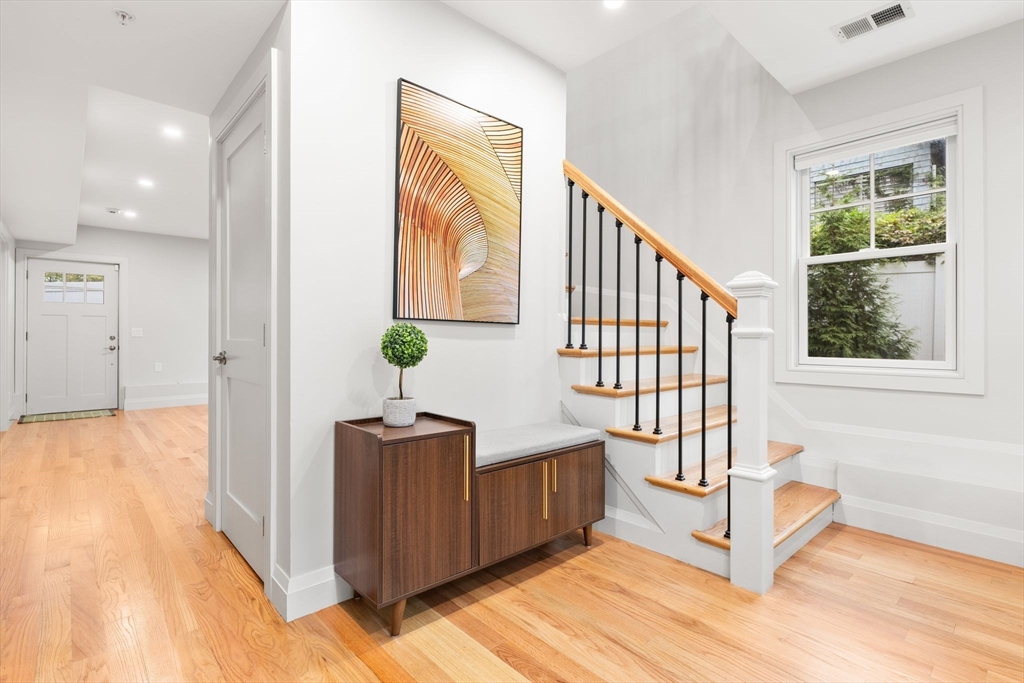 114 Broad Street, Unit D Weymouth, MA 02188 - Photo 11 of 41 a view of a hallway with wooden floor and staircase