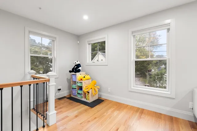 a view of a livingroom with wooden floor and a window