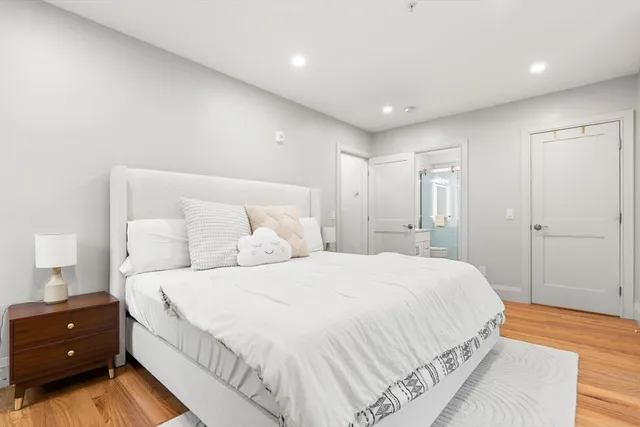 a bedroom with a bed and a night stand