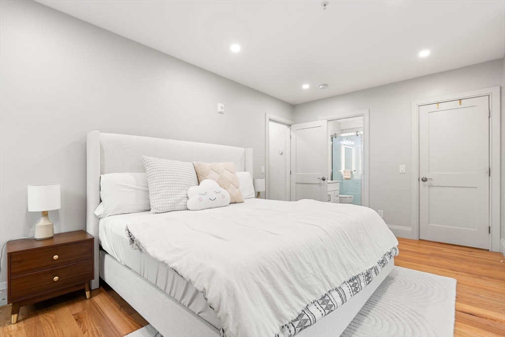 114 Broad Street, Unit D Weymouth, MA 02188 - Photo 15 of 41 a bedroom with a bed and a night stand