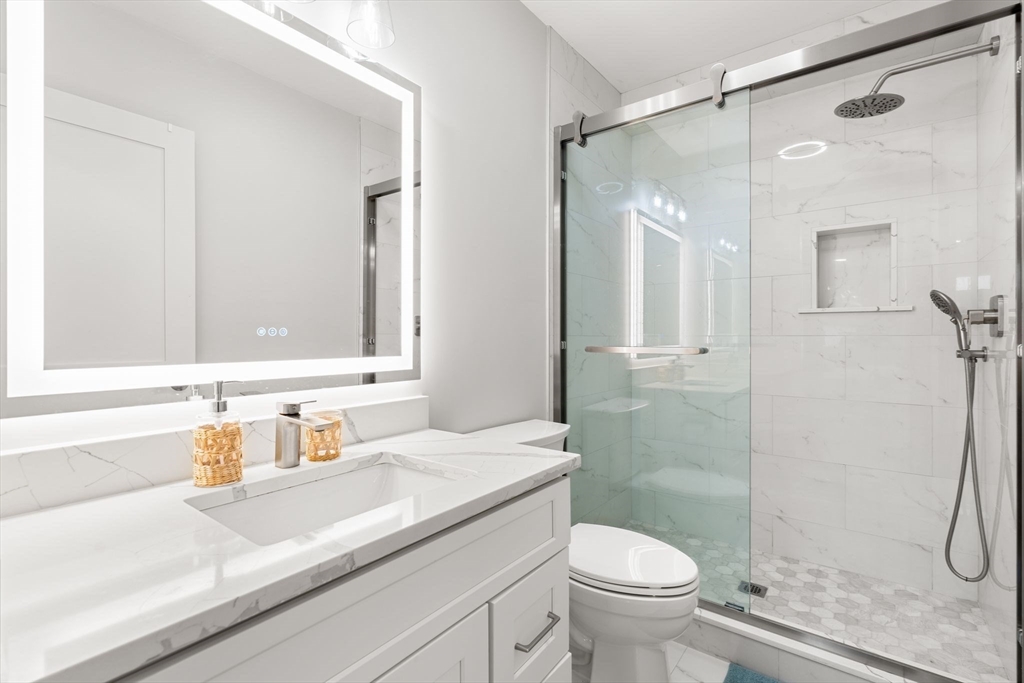 114 Broad Street, Unit D Weymouth, MA 02188 - Photo 19 of 41 a bathroom with a sink a toilet and shower